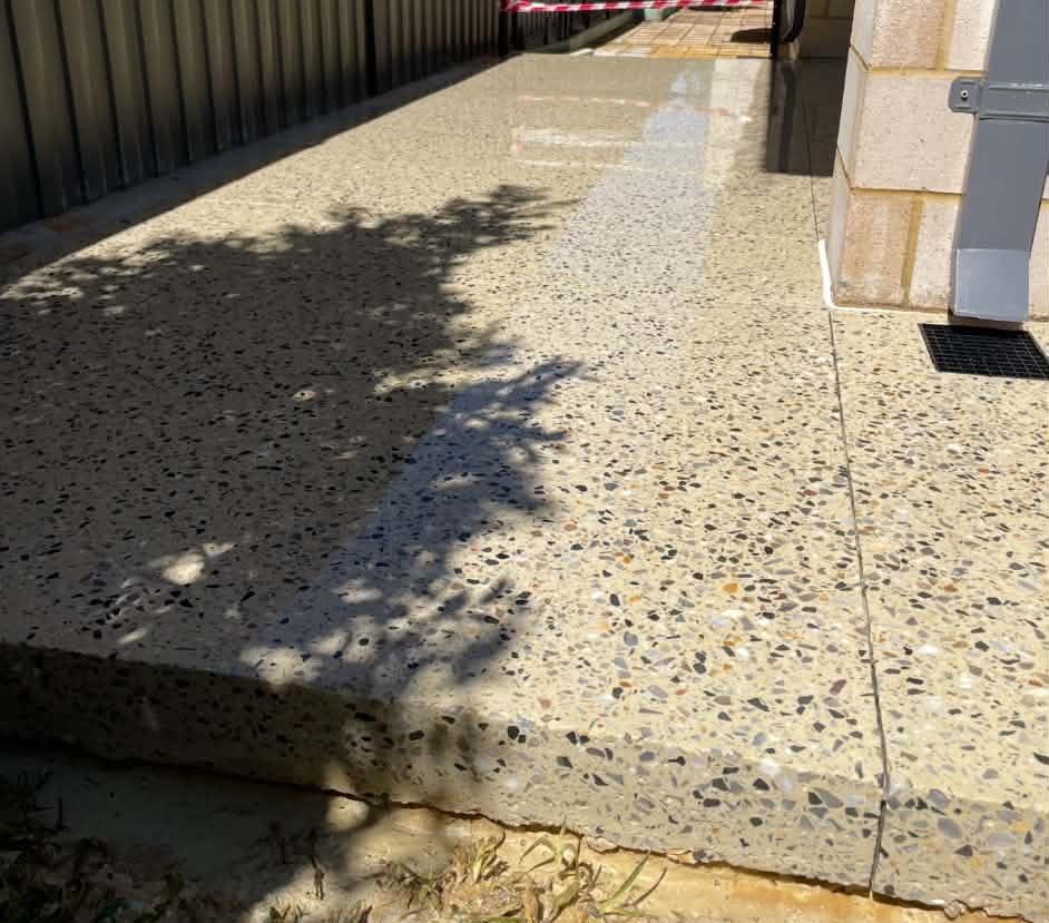 Wet-look polished concrete surface